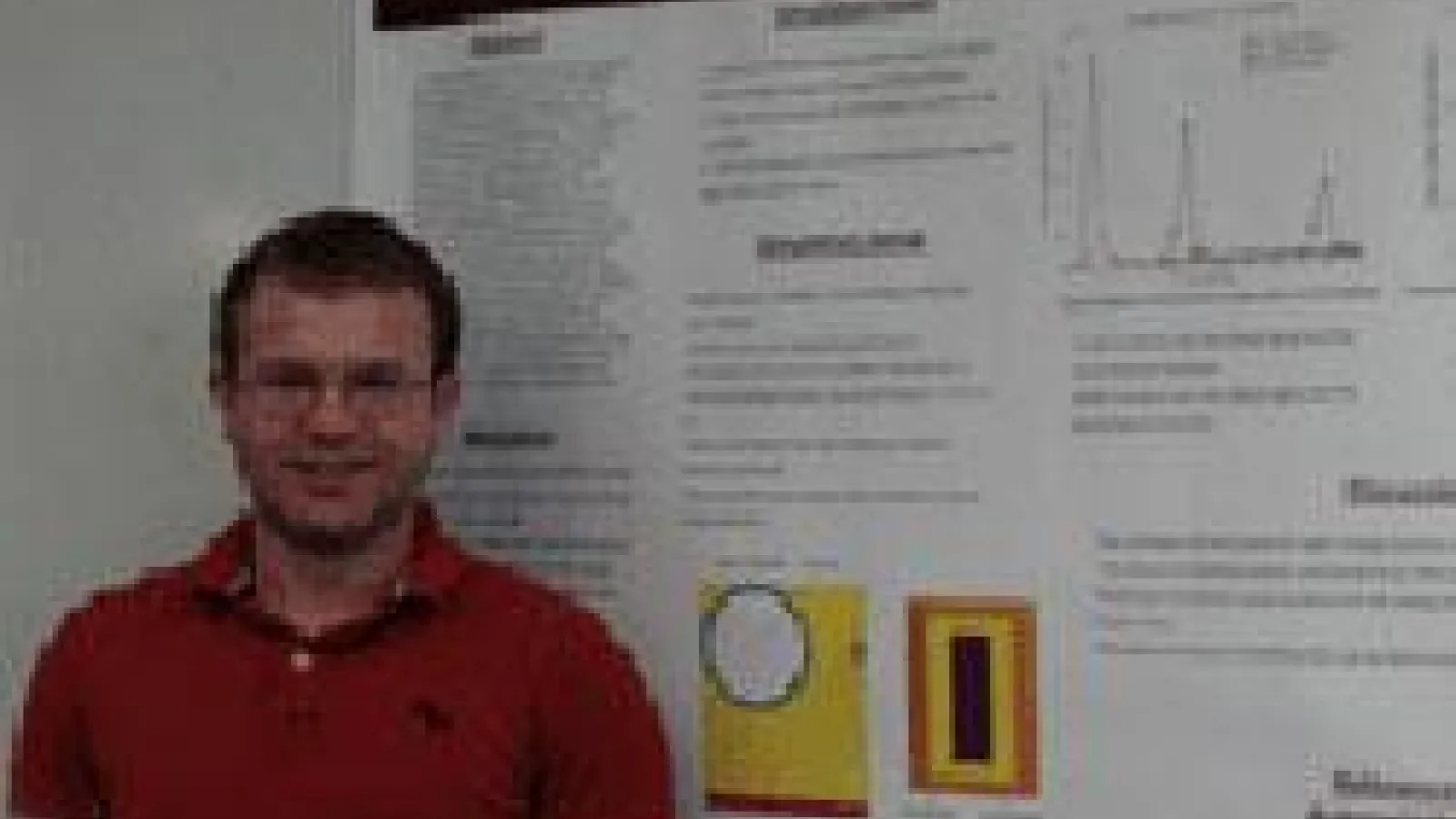Patrick Belancourt in front of poster
